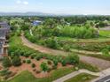 Scenic aerial view of the property and its surroundings, highlighting the lush greenery, walking path, and proximity to nature at 14823 W 70Th Dr # A, Arvada, CO 80007