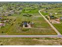 Aerial view of vast property, green pastures, fenced areas, main house and red barn at 41504 Vista Ridge, Parker, CO 80138