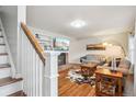 Bright living room with hardwood floors, a brick fireplace, large TV, and a cozy seating area at 6880 E Appleton Cir, Centennial, CO 80112