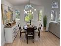 Cozy dining area with hardwood floors and natural light streaming through multiple windows at 1896 S Marshall Cir, Lakewood, CO 80232