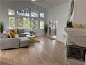 Bright living room with vaulted ceilings, large windows, hardwood floors and a cozy fireplace at 1896 S Marshall Cir, Lakewood, CO 80232