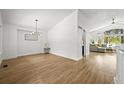 Open-concept living area with hardwood floors, bright lighting, and large windows offering natural light at 1896 S Marshall Cir, Lakewood, CO 80232