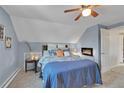 Cozy bedroom with a built-in electric fireplace and ample natural light at 4446 Parmalee Gulch Rd, Indian Hills, CO 80454