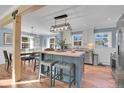 Eat-in kitchen featuring a butcher block island, pendant lighting, stainless appliances, and wood floors at 4446 Parmalee Gulch Rd, Indian Hills, CO 80454