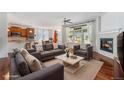 Inviting living room features a cozy fireplace, and an open layout to the kitchen and dining area at 26004 E Elmhurst Pl, Aurora, CO 80016