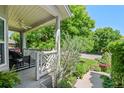 Cozy covered porch with stylish black and white accents, offering a relaxing outdoor seating area at 5272 W Capri Pl, Littleton, CO 80123