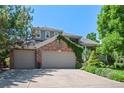 Charming two-story home boasts a lush lawn, mature trees, and an oversized attached garage at 5272 W Capri Pl, Littleton, CO 80123