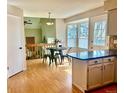 Bright breakfast nook with a round table, bar seating, and natural light from the windows at 9686 W 106Th Ave, Broomfield, CO 80021