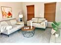 Cozy living room featuring neutral-toned furniture, a geometric coffee table, and natural light at 9686 W 106Th Ave, Broomfield, CO 80021
