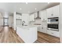 Bright kitchen with white cabinets, stainless steel appliances, and an island at 3361 N Buchanan Way, Aurora, CO 80019