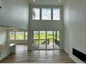 Spacious living room with high ceilings, large windows and sliding glass doors that lead to the deck at 13358 Blue Amber Ct, Parker, CO 80134