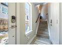 The foyer features tile floors, stairs leading to the upper level, and a view of the outdoors through a window at 2790 W 25Th Ave # 6, Denver, CO 80211