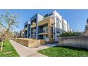 Modern townhome exterior with wooden accents, fenced yard and landscaping at 2790 W 25Th Ave # 6, Denver, CO 80211