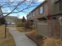 Well-maintained townhomes feature brick accents, patios, and beautifully landscaped common areas at 559 Alton Way # C, Denver, CO 80230