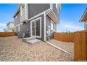 The house exterior features a low-maintenance backyard with gravel and a privacy fence at 13029 E 103Rd Pl, Commerce City, CO 80022