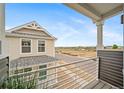 A view from the balcony showcasing the neighborhood and the adjacent house at 13029 E 103Rd Pl, Commerce City, CO 80022