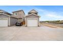 Detached garage with a wide driveway, providing ample parking space at 13029 E 103Rd Pl, Commerce City, CO 80022