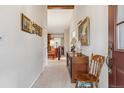 Inviting hallway showcasing classic decor, a wooden chair, and an open view into a cozy living area at 9954 W Progress Pl, Littleton, CO 80123