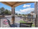 Private balcony shows lovely view of neighboring condos and green space from seating area at 7440 S Blackhawk St # 14-208, Englewood, CO 80112
