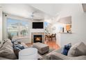 Bright living room with fireplace, large windows, and open access to dining area and kitchen at 7440 S Blackhawk St # 14-208, Englewood, CO 80112