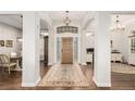 Inviting foyer boasts gleaming floors, an elegant light fixture, and natural light at 12467 Topaz Vista Way, Castle Pines, CO 80108