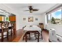Bright dining area featuring a ceiling fan and a large window bringing in lots of natural light at 1430 Mount Evans Dr, Longmont, CO 80504