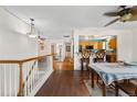 Inviting entryway showcasing hardwood floors that flow into the dining and kitchen area with bar seating at 1430 Mount Evans Dr, Longmont, CO 80504