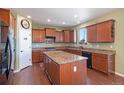 Spacious kitchen with granite counters, modern appliances, and island, with adjacent walk-in pantry at 42395 Forest Oaks Dr, Elizabeth, CO 80107