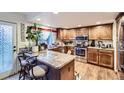 Well-equipped kitchen with ample counter space, stainless steel appliances, and natural lighting at 7920 E Phillips Cir, Centennial, CO 80112