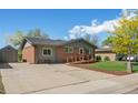Lovely brick home with a convenient ramp, spacious driveway, and a well-kept front lawn at 717 E 4Th Ave, Longmont, CO 80504