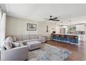 Open-concept living room with hardwood floors, neutral colors, and abundant natural light at 8004 S Field St, Littleton, CO 80128