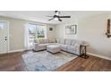 Bright and airy living room featuring hardwood floors, a comfortable sectional sofa, and natural light at 8004 S Field St, Littleton, CO 80128
