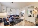Modern living room with a comfortable blue sofa, stylish rug, and contemporary artwork at 1680 Simms St, Lakewood, CO 80215