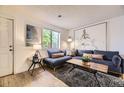 Cozy living room with large window, plush sofa, and decorative pillows at 1680 Simms St, Lakewood, CO 80215