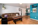 Inviting living room featuring hardwood floors, neutral walls, and a comfortable seating area for relaxing at 6903 W 52Nd Pl, Arvada, CO 80002