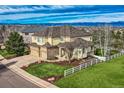 Charming home featuring well-manicured lawn, a white fence, and a three-car garage at 10337 Carriage Club Dr, Lone Tree, CO 80124