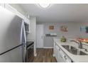 Modern kitchen with stainless steel appliances, gray countertops and wooden floors at 2575 S Syracuse Way # M206, Denver, CO 80231