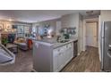 Open-concept floor plan featuring modern kitchen overlooking the living room with fireplace at 2575 S Syracuse Way # M206, Denver, CO 80231
