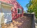 Exterior shot of a home with a wooden deck and a white front door at 1125 S Oneida St # F, Denver, CO 80224