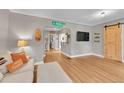 Bright living room featuring hardwood floors, modern decor, and a stylish sliding barn door at 4848 Hooker St, Denver, CO 80221