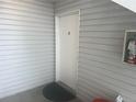 Front door entrance with light gray siding and a doormat at 14453 E Jewell Ave # 104, Aurora, CO 80012