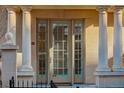 Townhome entrance with columns and double French doors at 1950 N Logan St # 102, Denver, CO 80203