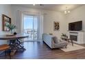 Bright living room with access to a balcony, hardwood floors, and fireplace at 9283 Twenty Mile Rd # 403, Parker, CO 80134