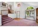 Spacious foyer with high ceiling, arched window, and staircase leading to the upper level at 11366 Haswell Dr, Parker, CO 80134