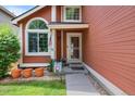Inviting front door entrance with decorative plants, welcoming sign, and a secure SafeStreets system at 11366 Haswell Dr, Parker, CO 80134