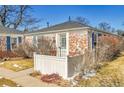 Cozy brick home featuring blue shutters and a well-kept front yard at 1209 Locust St, Denver, CO 80220