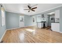 Bright living room boasts hardwood floors and an open layout to the kitchen at 1209 Locust St, Denver, CO 80220