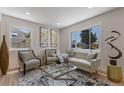 Bright living room with stylish furniture, a large window, and hardwood floors, creating a welcoming atmosphere at 1670 S Quieto Ct, Denver, CO 80223