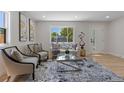 Bright living room with stylish furniture, a large window, and hardwood floors, creating a welcoming atmosphere at 1670 S Quieto Ct, Denver, CO 80223