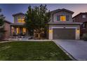 Two-story house with landscaped yard and two-car garage at dusk at 2263 S Loveland St, Denver, CO 80228